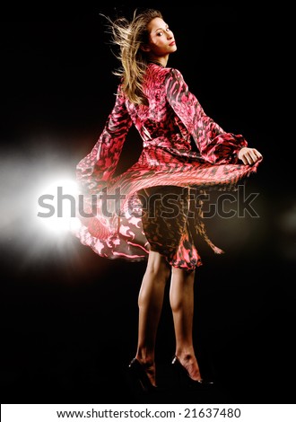 Studio fashion with woman in flowing red dress