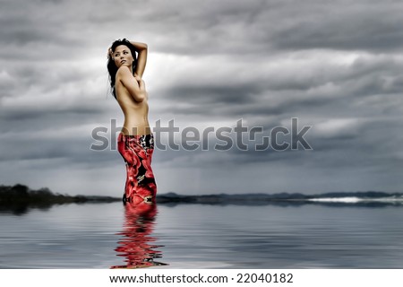 stock photo Beautiful woman poses topless on beach in stormy weather