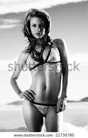 Black and white image of bikini model on beach