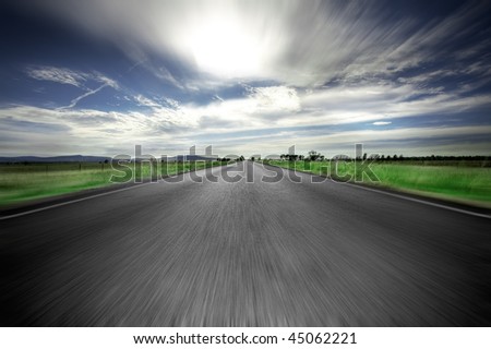 Road going straight ahead with motion blur