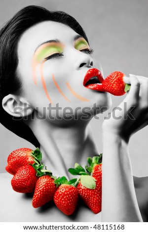 Creative makeup beauty shot of model with strawberries, artistic edit