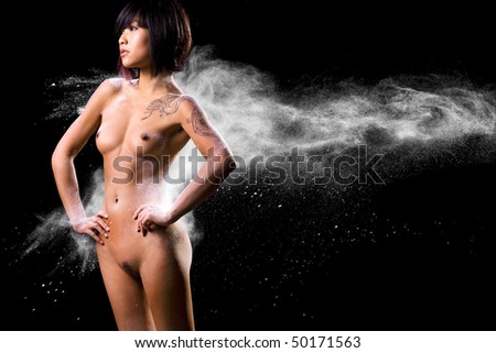 stock photo Asian naked women hit by thrown powder on black background
