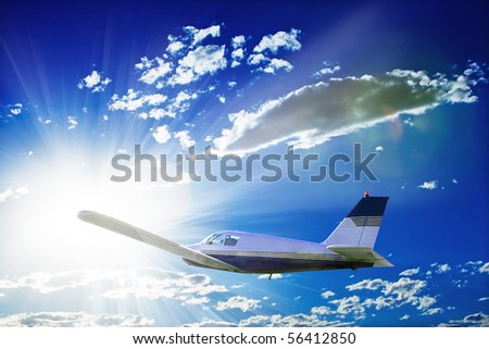 Small plane flying through sky with sun in background