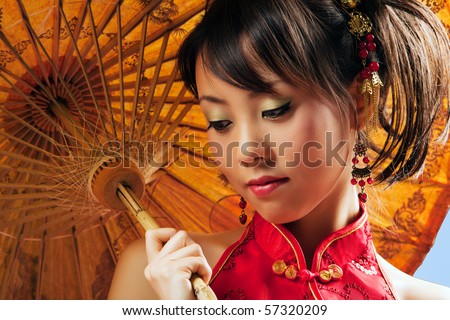 Chinese girl with parasol wearing a cheongsam