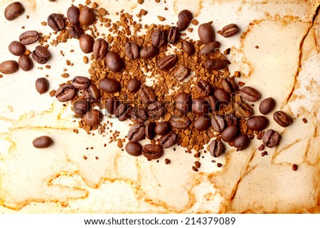 Coffee beans with soluble coffee on vintage paper background