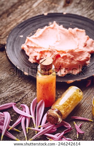Spa still life with butter for body on wooden background