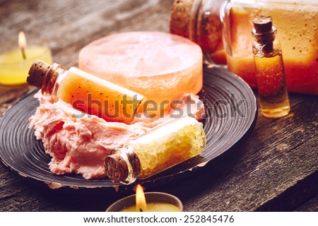 Soap, sea salt, scrub and butter for body on wooden background