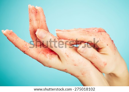Female hands in body scrub on blue background
