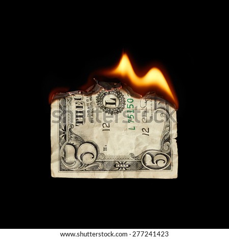 Burning dollar on black background
