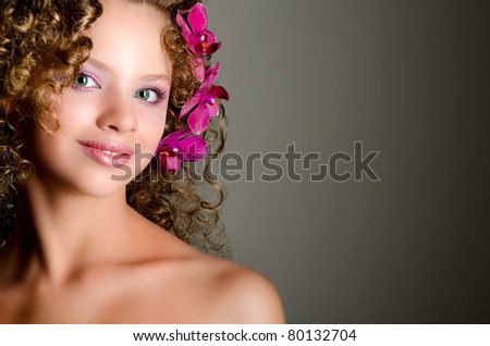 Young lady with purple orchid flowers