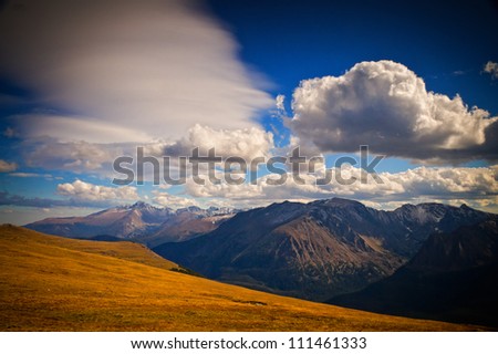 Longs Peak touches the clouds along the alpine tundra areas of Rocky Mountain National Park, Colorado on beautiful Fall day