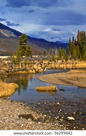 Rocky Mountain National Park in Colorado sets the scene with a lazy river and the Rocky Mountains