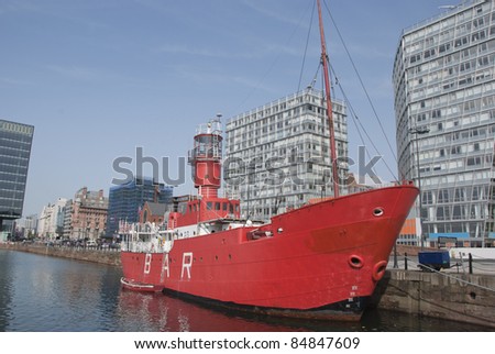 A Red Lighthouse Ship in an English City Dock