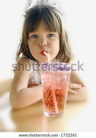 Young girl drinking soda with a straw.