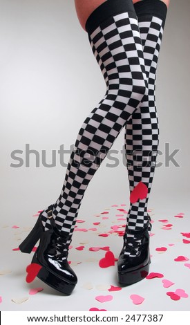 stock photo Woman wearing checkered stockings and high heels surrounded