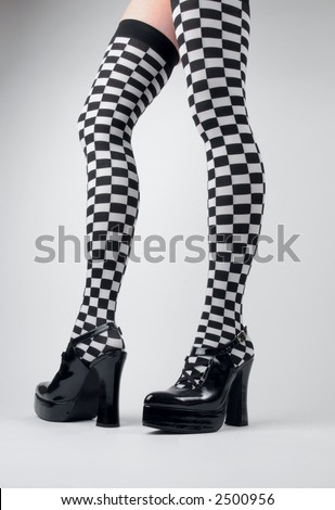 Woman in checkered stockings and high heels