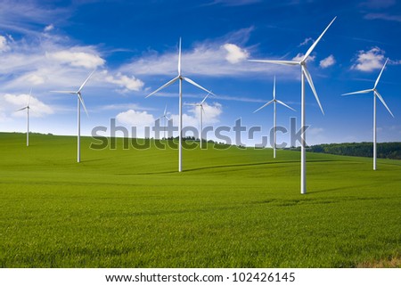 Wind turbine farm in the field - a renewable energy source
