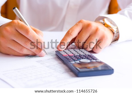 Businessman calculating financial results in the office