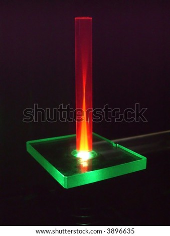 a rod of artificial ruby illuminated from bottom by a green laser beam