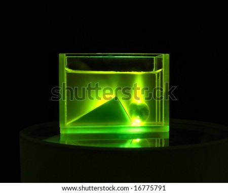 glass prism and ball immersed into a dye solution under laser beam. The ball acts like a lens focusing laser beam