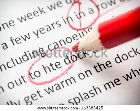 Correcting an essay with red pencil