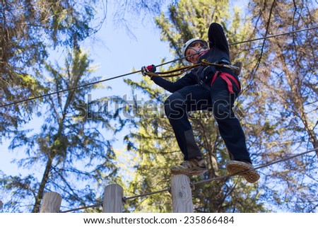 young woman having fun in an outdoor adventure park