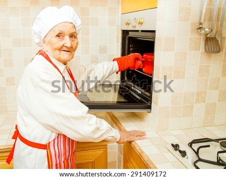 Grandmother at home preparing food in the kitchen.
