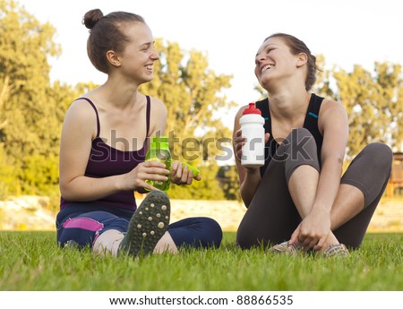Two girls having a rest, drinking