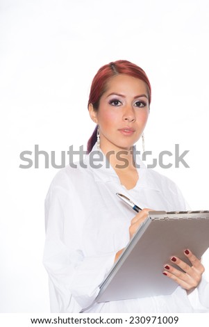 Young hispanic woman wearing a lab coat while holding a clipboard and standing