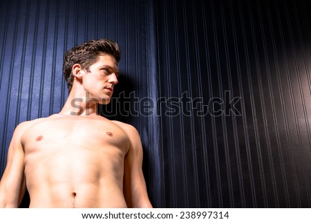 Shirtless Toned Caucasian Male Leans Against Wall