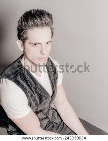 Young Dark Hair Green Eye Male In V-Neck And Vest