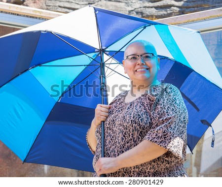 Woman stands beneath umbrella to protect sensitive skin from sun