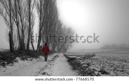 Man walking in the fog and snow