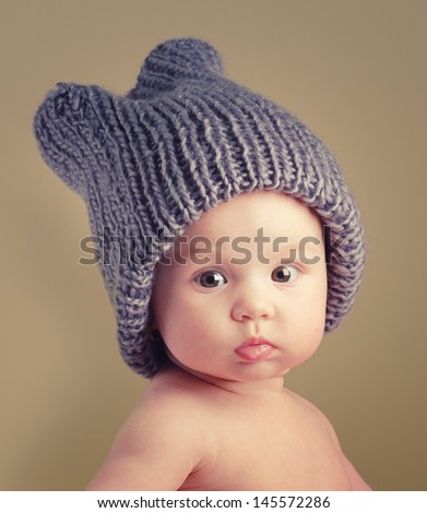 Portrait Of Cute Happy 4 Month Old Baby Girl With Funny Hat. Photo Of Funny Babe.
