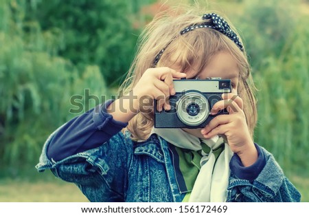 Little Girl Taking Picture Using Vintage Film Camera
