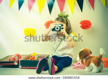 Little girl taking pictures with a vintage film camera.
