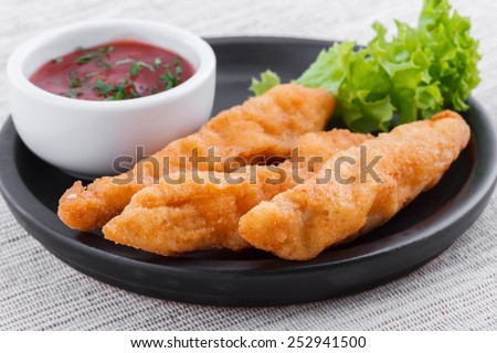 Fried fish fingers with sauce