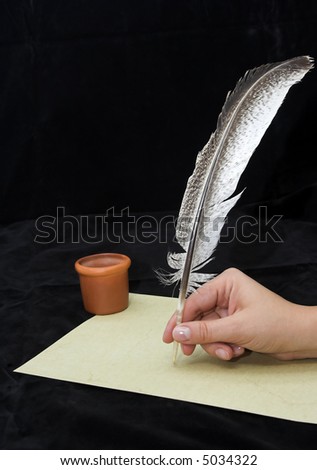 Hand writting with feather isolated on black  background