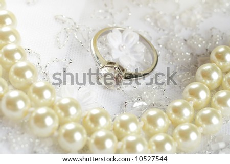 Nice wedding background wedding dress fabric with pearls,engagement ring and a rose