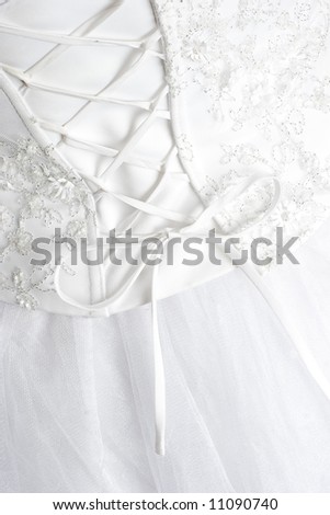  Detail of a woman's wedding dress gown showing curve of back with corset