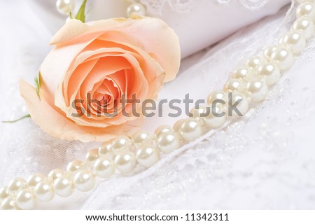 Textile wedding background with rose and pearls