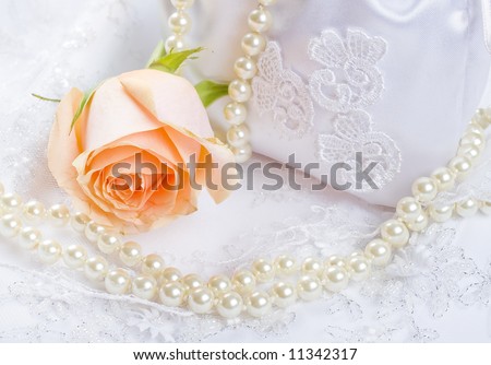 Textile wedding background with rose and pearls