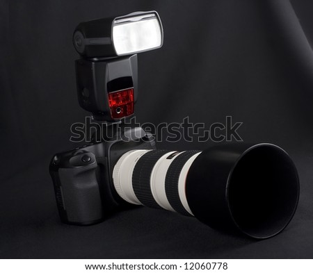 Professional digital photo camera with zoom lens on black background