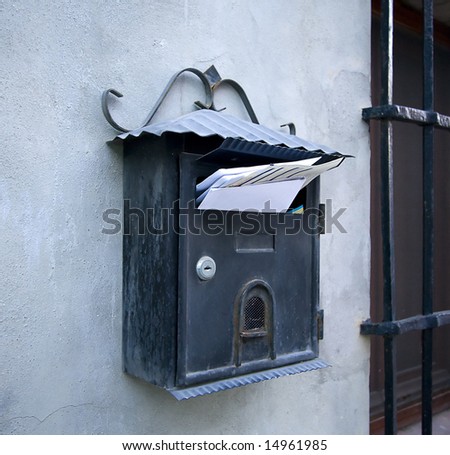 mail box on a wall full of letters