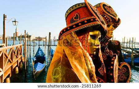 Traditionally dressed Venice carnival couples in Piazza San Marco, Italy