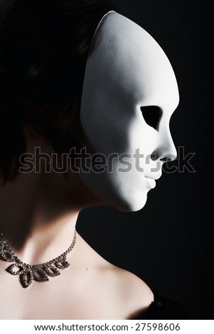 Dark portrait of a beautiful girl with white mask