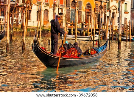 Gondolier navigates the venetian canal