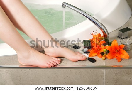 woman legs with flowers in spa salon.shallow DOF