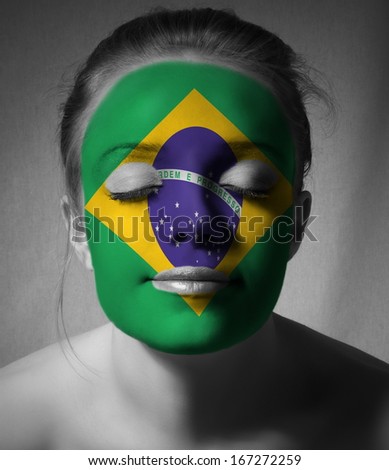 closeup of fashion woman with brasil flag on face