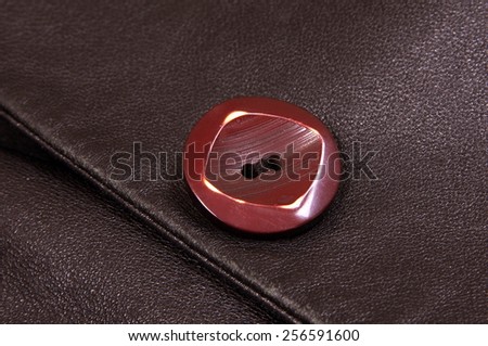 button on the leather coat